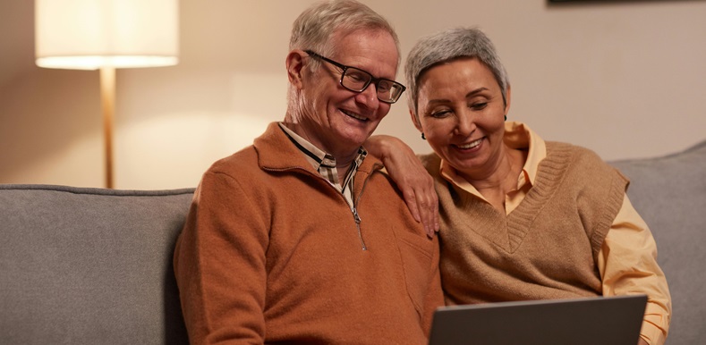 Elderly Couple Looking at Laptop