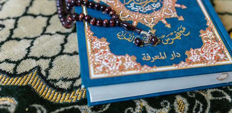 A Brown Misbaha on Blue Quran