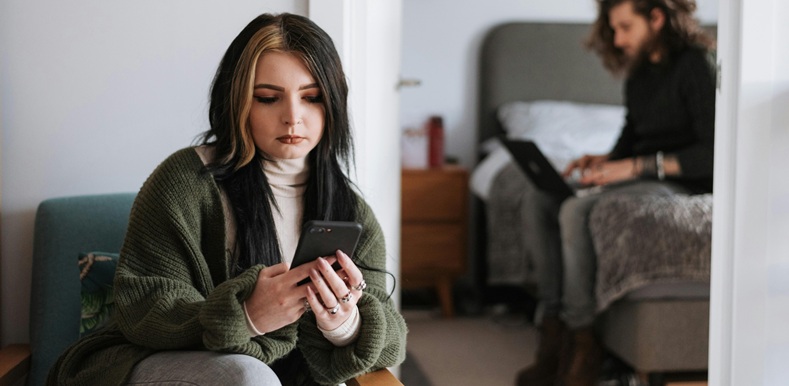 Woman using phone at home