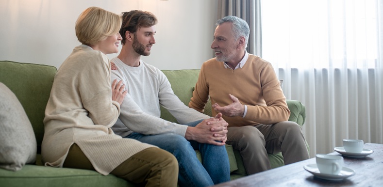 Family together. Son visiting his parents and talking to them